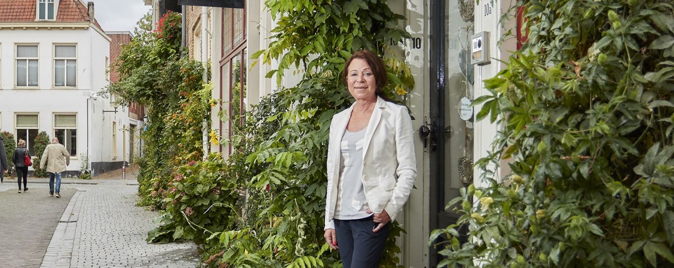 Marianne poserend voor haar huis in het centrum van Bergen op Zoom